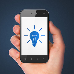 Image showing Finance concept: smartphone with Light Bulb.
