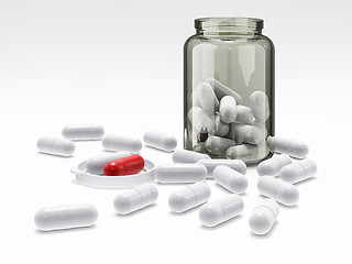 Image showing White and red pills in medical bottle on white