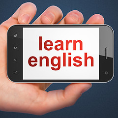 Image showing Hand holding smartphone with word learn english