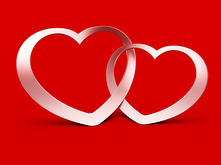 Image showing Two jointed hearts on red