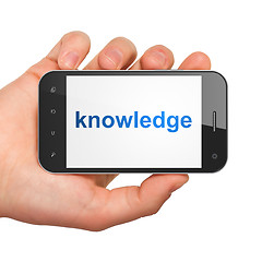 Image showing Hand holding smartphone with word knowledge