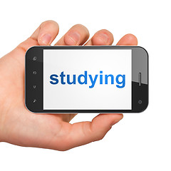 Image showing Hand holding smartphone with studying on display