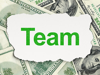 Image showing Torn paper with words Team on money background