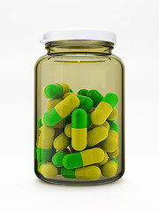 Image showing Green-yellow pills in medical bottle on white