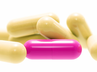 Image showing Pink and beige pills on white