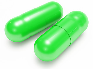 Image showing Two shiny green pills (medical capsules)