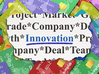 Image showing Torn newspaper with words innovation on credit card background