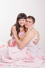 Image showing Young beautiful girl embraces the guy in bed