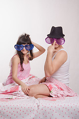 Image showing Young couple sitting in bed with big glasses