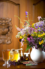 Image showing Still life from medicinal herbs, honey, herbal tea and medicines