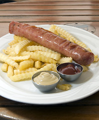 Image showing authentic kielbasa Polish sausage with french fries as photogpra