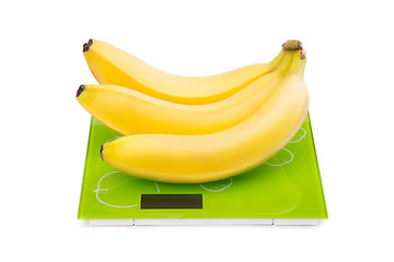 Image showing Three yellow bananas on scales