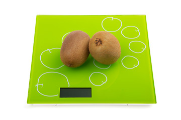 Image showing Two kiwi fruit on scales