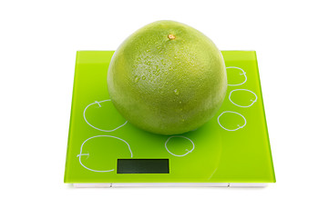 Image showing Sweetie fruit on square kitchen scales