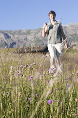 Image showing Hiking woman in a mountain meadow