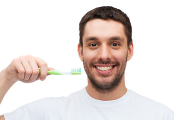 Image showing smiling young man with toothbrush