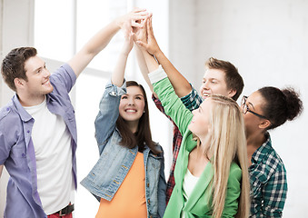 Image showing happy students giving high five at school