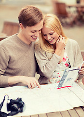 Image showing couple with map, camera and travellers guide