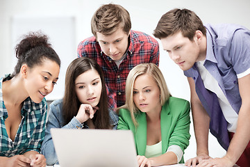 Image showing international students looking at laptop at school