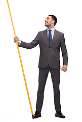 Image showing smiling man holding flagpole with imaginary flag