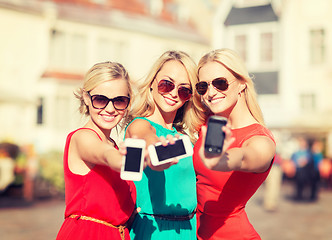 Image showing beautiful girls with smartphones in the city