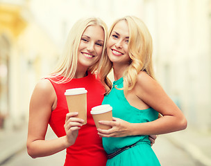 Image showing women with takeaway coffee cups in the city