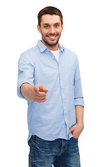 Image showing smiling man pointing finger at you