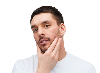 Image showing beautiful calm man touching his face