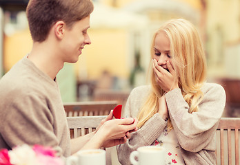 Image showing romantic man proposing to beautiful woman