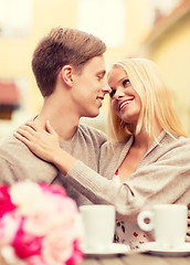 Image showing romantic happy couple kissing in the cafe