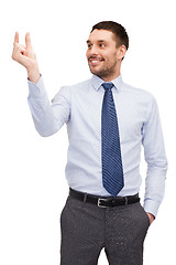 Image showing handsome buisnessman holding imaginary light bulb