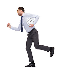 Image showing smiling young businessman with clock running