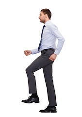 Image showing serious businessman stepping on imaginary step