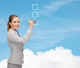 Image showing businesswoman writing something in air with marker