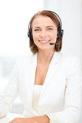 Image showing smiling female helpline operator with headphones