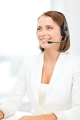 Image showing smiling female helpline operator with headphones