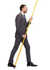 Image showing smiling man holding flagpole with imaginary flag