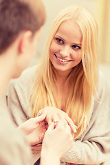 Image showing romantic man proposing to beautiful woman