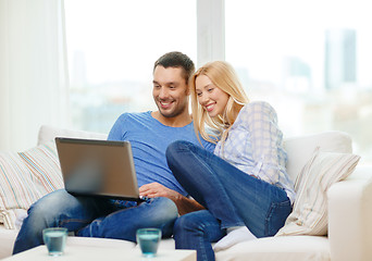 Image showing smiling happy couple with laptop at home