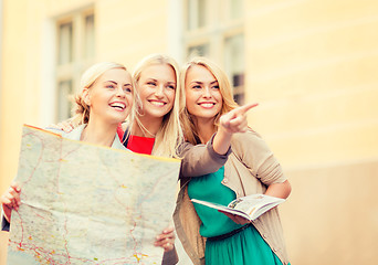 Image showing beautiful women with tourist map in the city