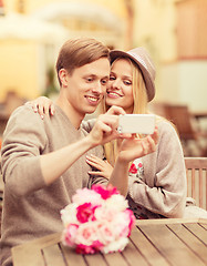 Image showing couple taking picture with smartphone