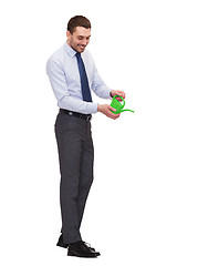Image showing handsome buisnessman with green watering can