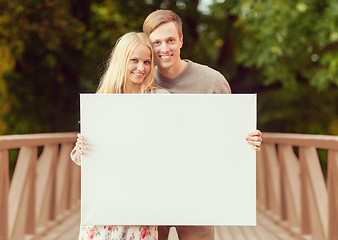 Image showing couple on the bridge with blank white board