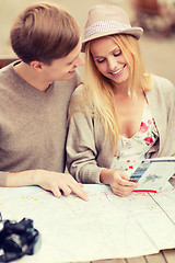 Image showing couple with map, camera and travellers guide