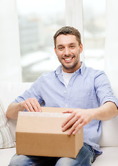 Image showing man with cardboard boxes at home
