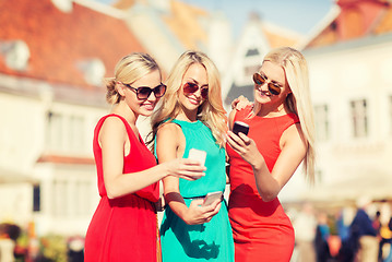 Image showing beautiful girls with smartphones in the city