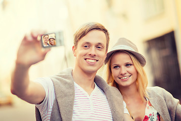 Image showing travelling couple taking photo picture with camera