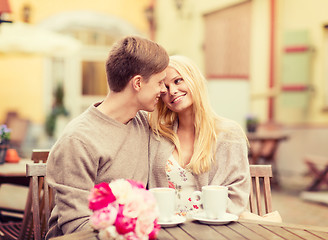 Image showing romantic happy couple kissing in the cafe