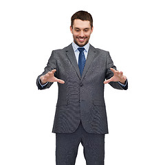 Image showing businessman working with imaginary virtual screen