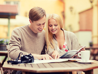 Image showing couple with map, camera and travellers guide